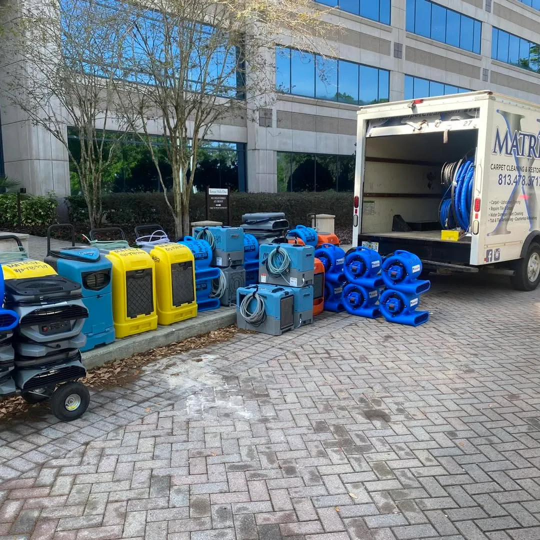 Air movers and dehumidifiers unloaded from a Matrix van on arrival