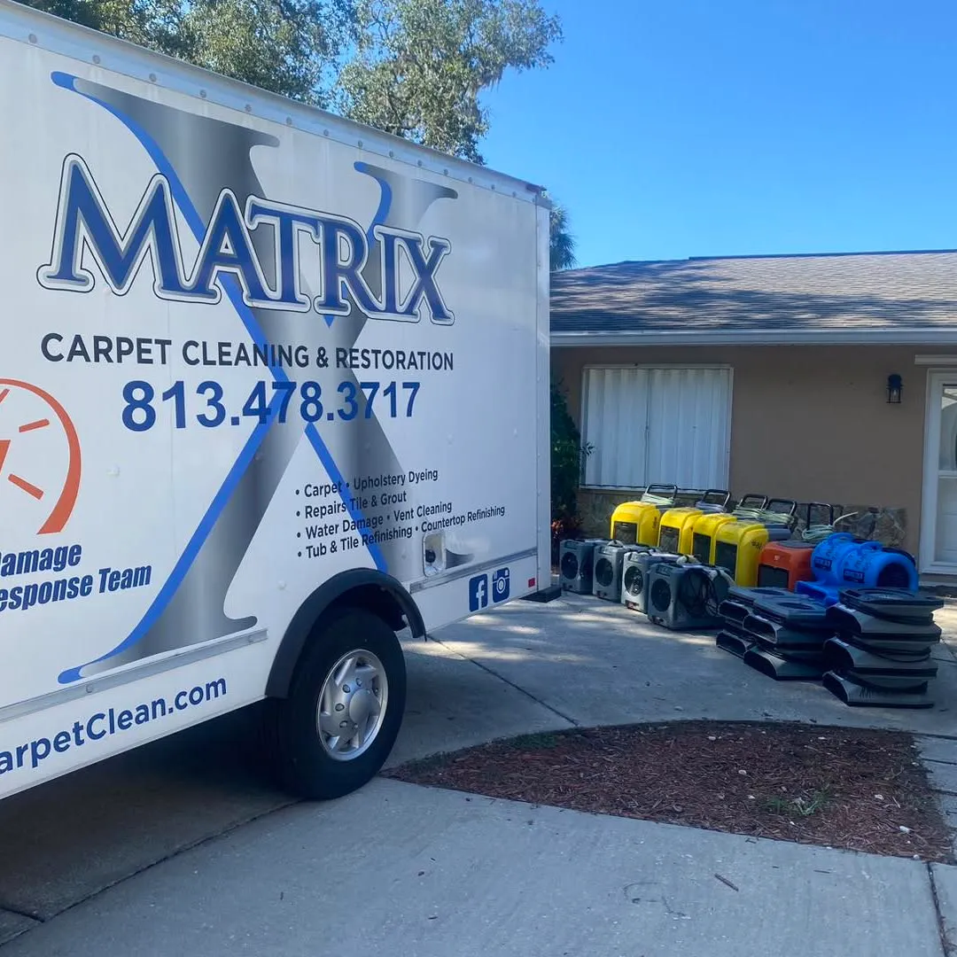 The branded Matrix box truck parked at a house with equipment unloaded