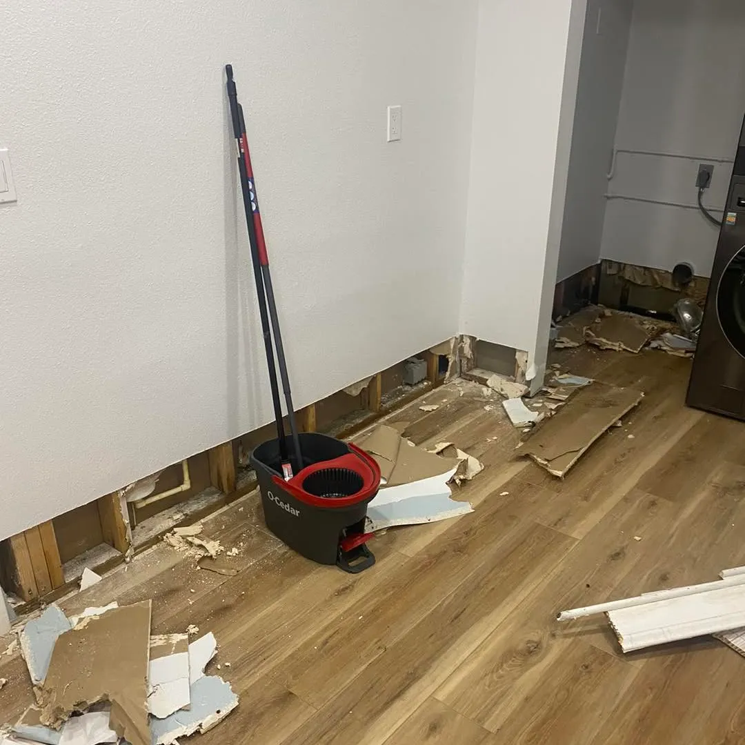 Wet drywall cut away, debris across the floor