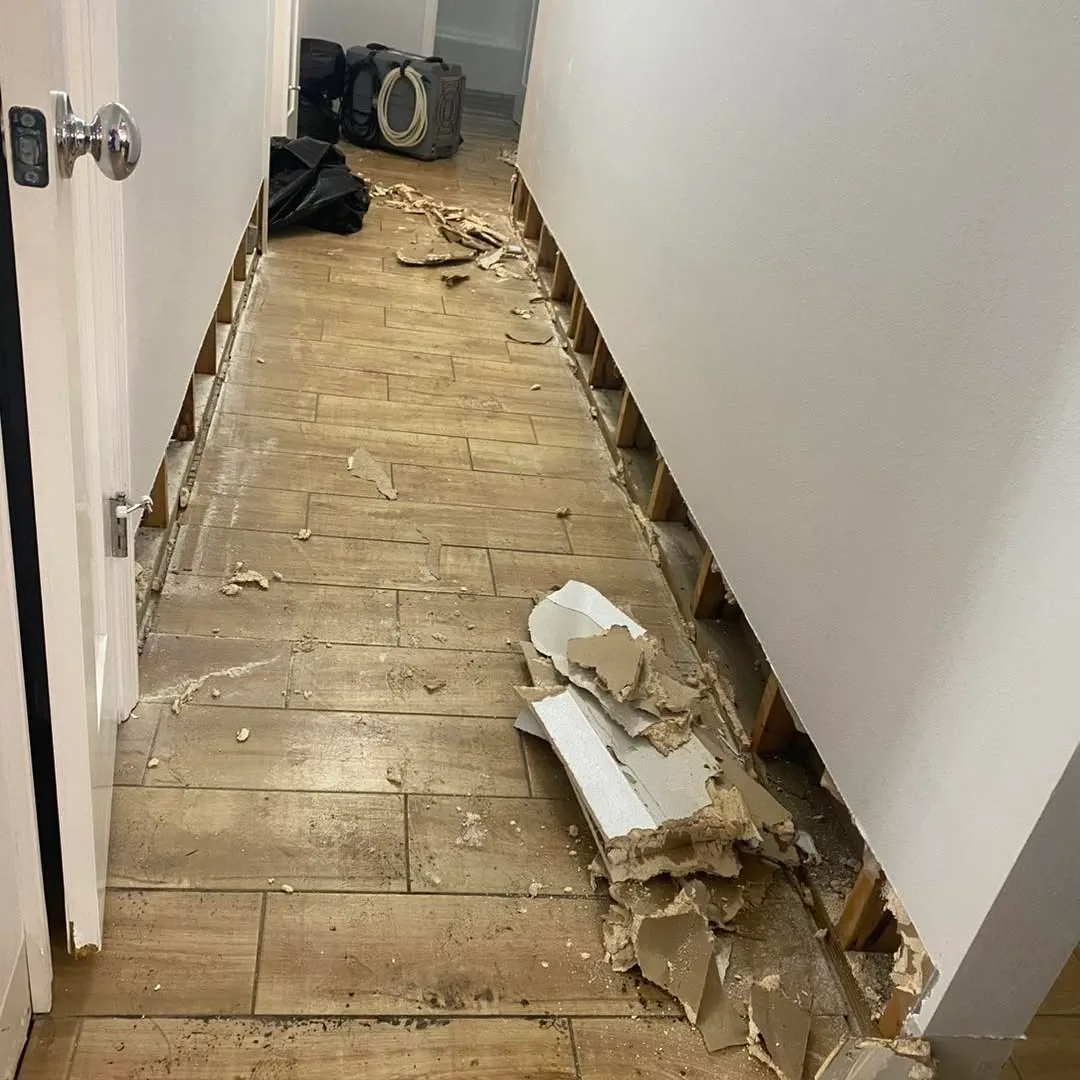 Buckled hallway flooring lifted after a water loss