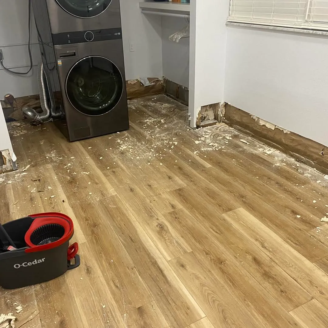 A laundry room stripped back to the subfloor